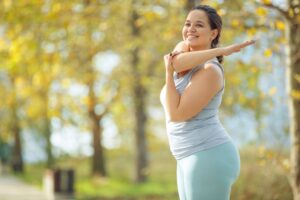 Overweight woman stretching to help reduce fatigue from semaglutide