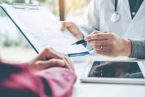 A doctor showing a patient an informed consent form for GLP-1s