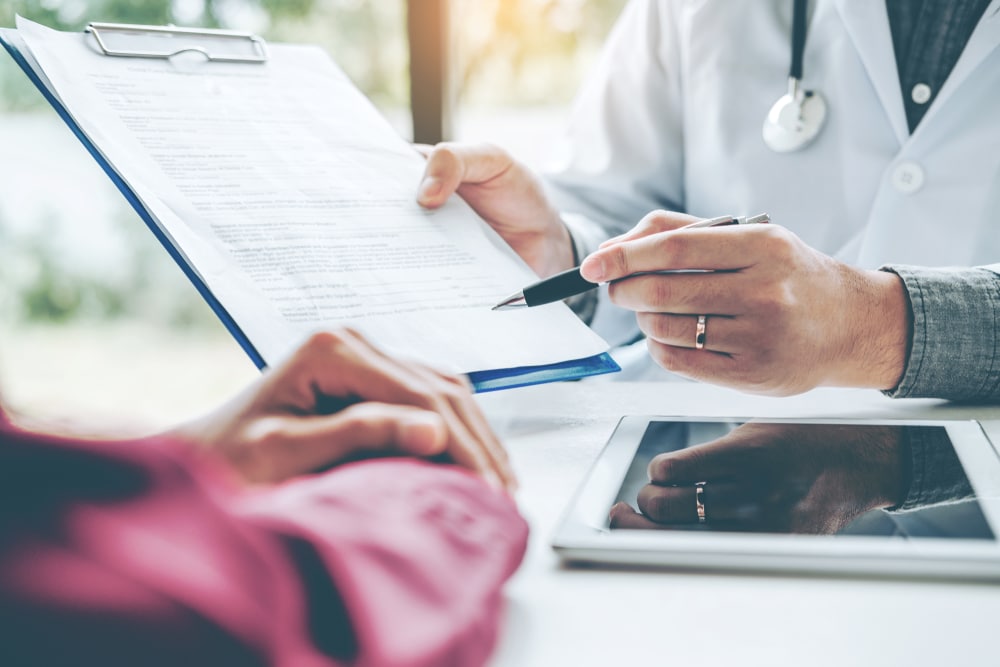 A doctor showing a patient an informed consent form for GLP-1s