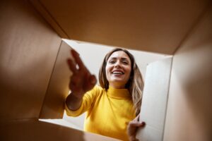 Woman opening a GLP-1 box delivered to her door