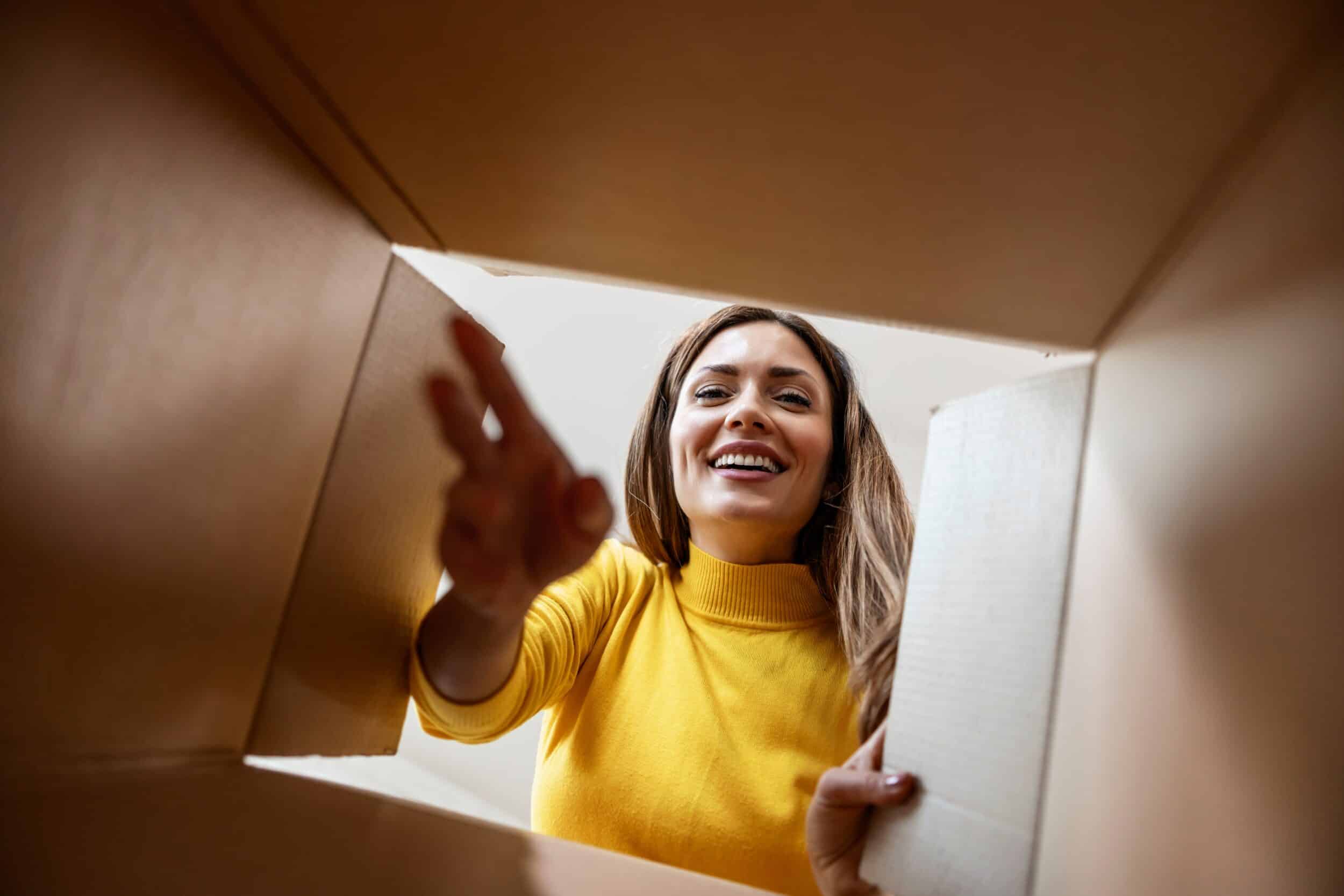 Woman opening a GLP-1 box delivered to her door