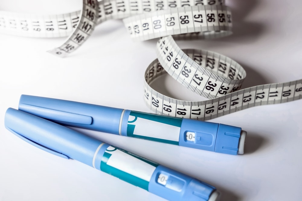 GLP-1 injection pens with measuring tape representing medical weight loss treatment and compounded therapy options